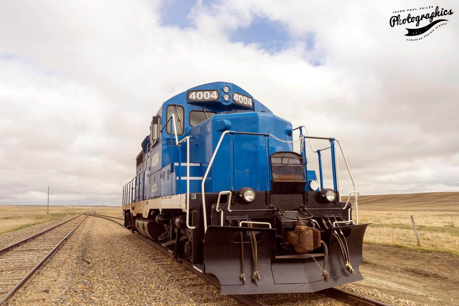Blue train sitting on a track